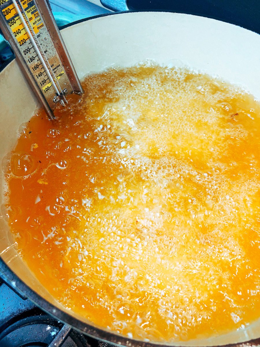 a candy thermometer in hot oil in a Dutch Oven 