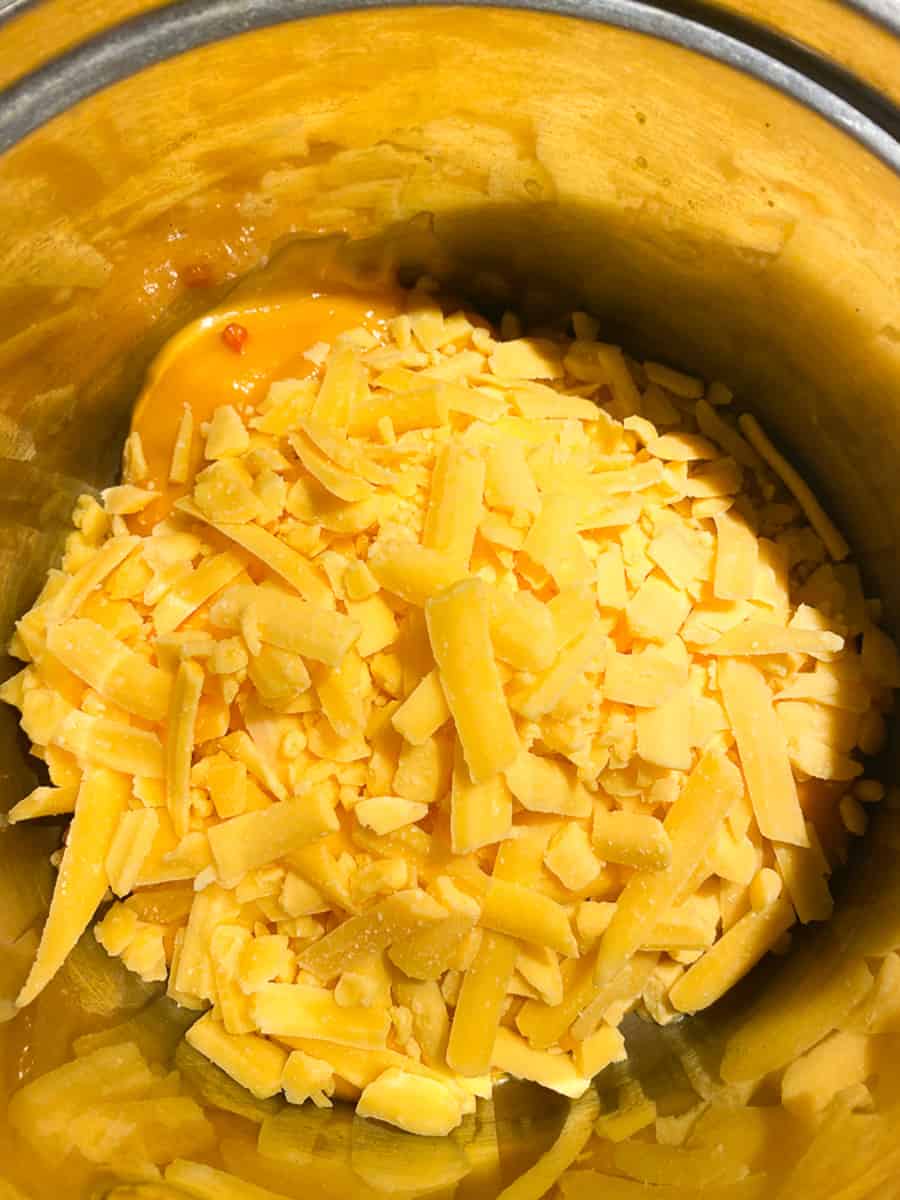 Shredded cheese melting with Fiesta Nacho cheese in a saucepan 