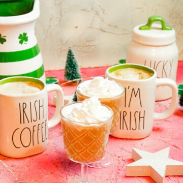 two Irish glass coffee mugs filled to the brim with Irish lattes that taste like honey and Saint Patrick's Day all rolled into one