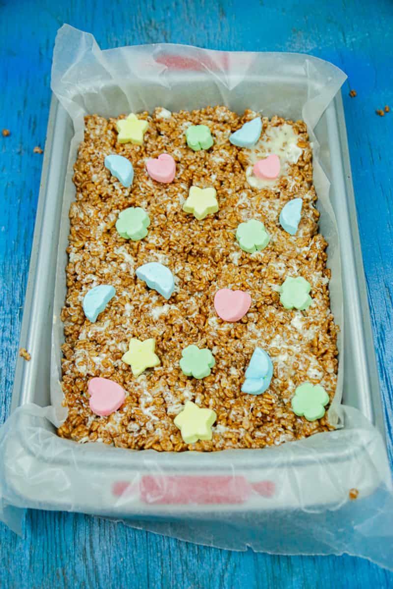 a tray of chocolate rice krispie treats with colored marshmallows on top 