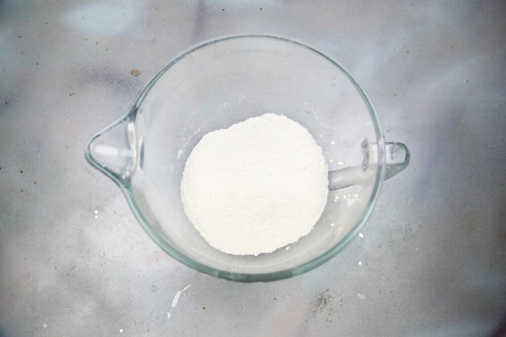 a glass bowl with dry ingredients in it 