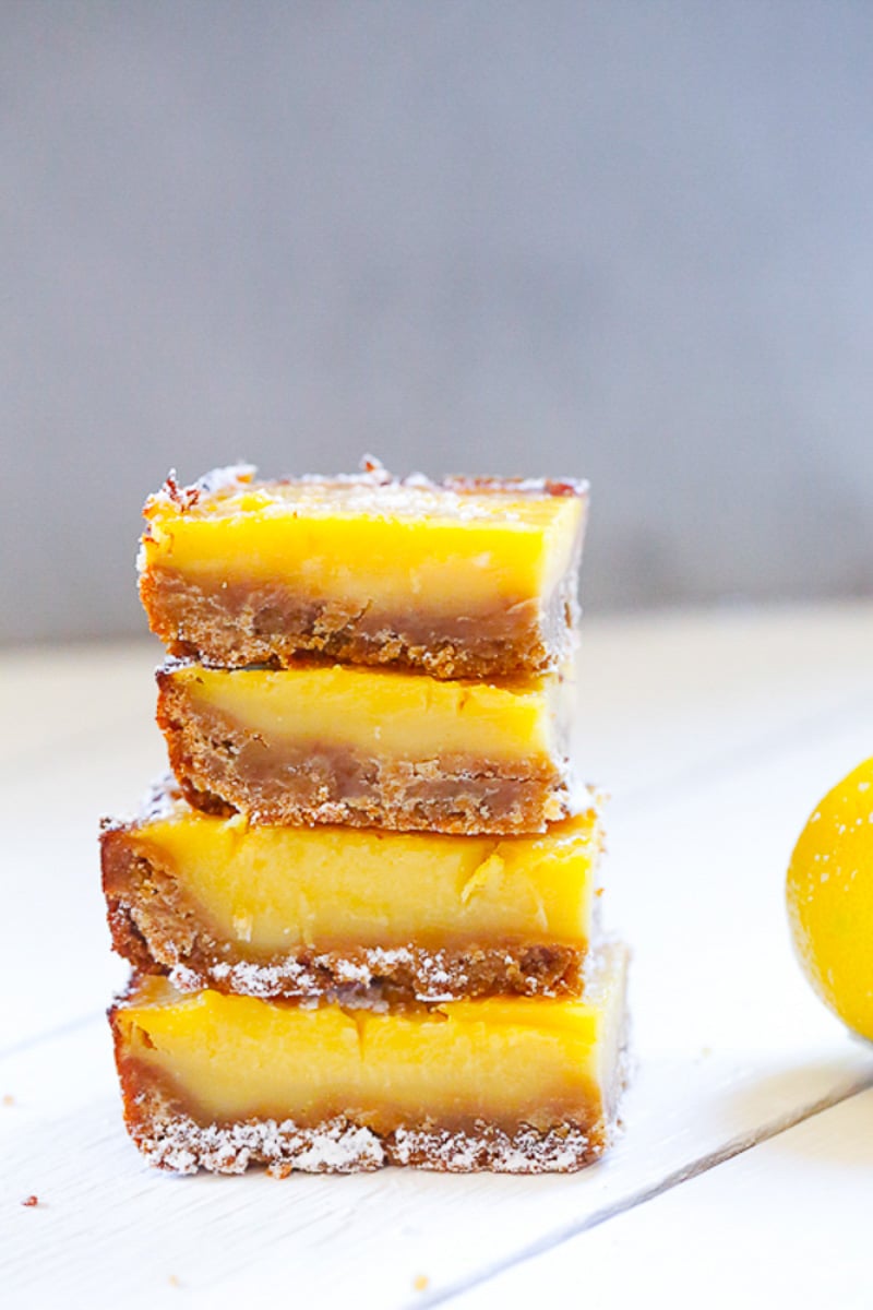 A stack of yellow lemon bars with an almond flour crust 