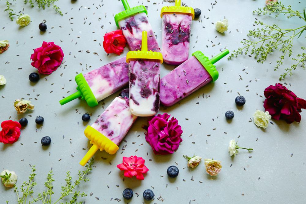 A bunch of healthy lavender blueberry honey popsicles that are dairy free 