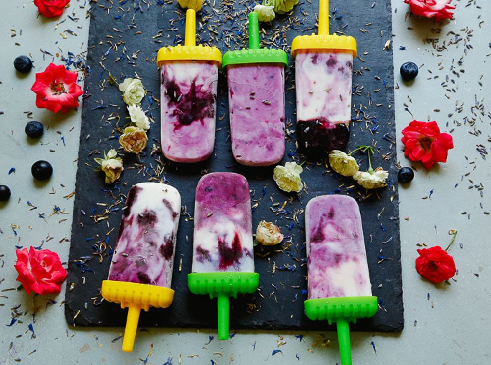 A row of delicious dairy-free blueberry lavender popsicles made with coconut milk