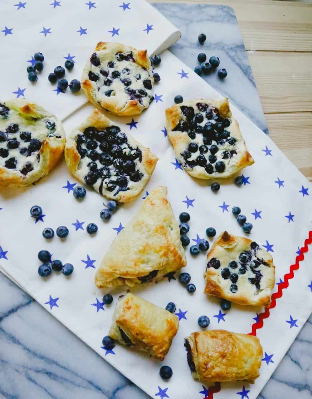 Fourth of July setting with baked fruit turnovers sitting on a marble back drop 