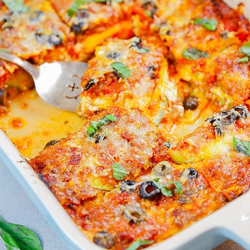 zucchini casserole in a tray and a serving spoon