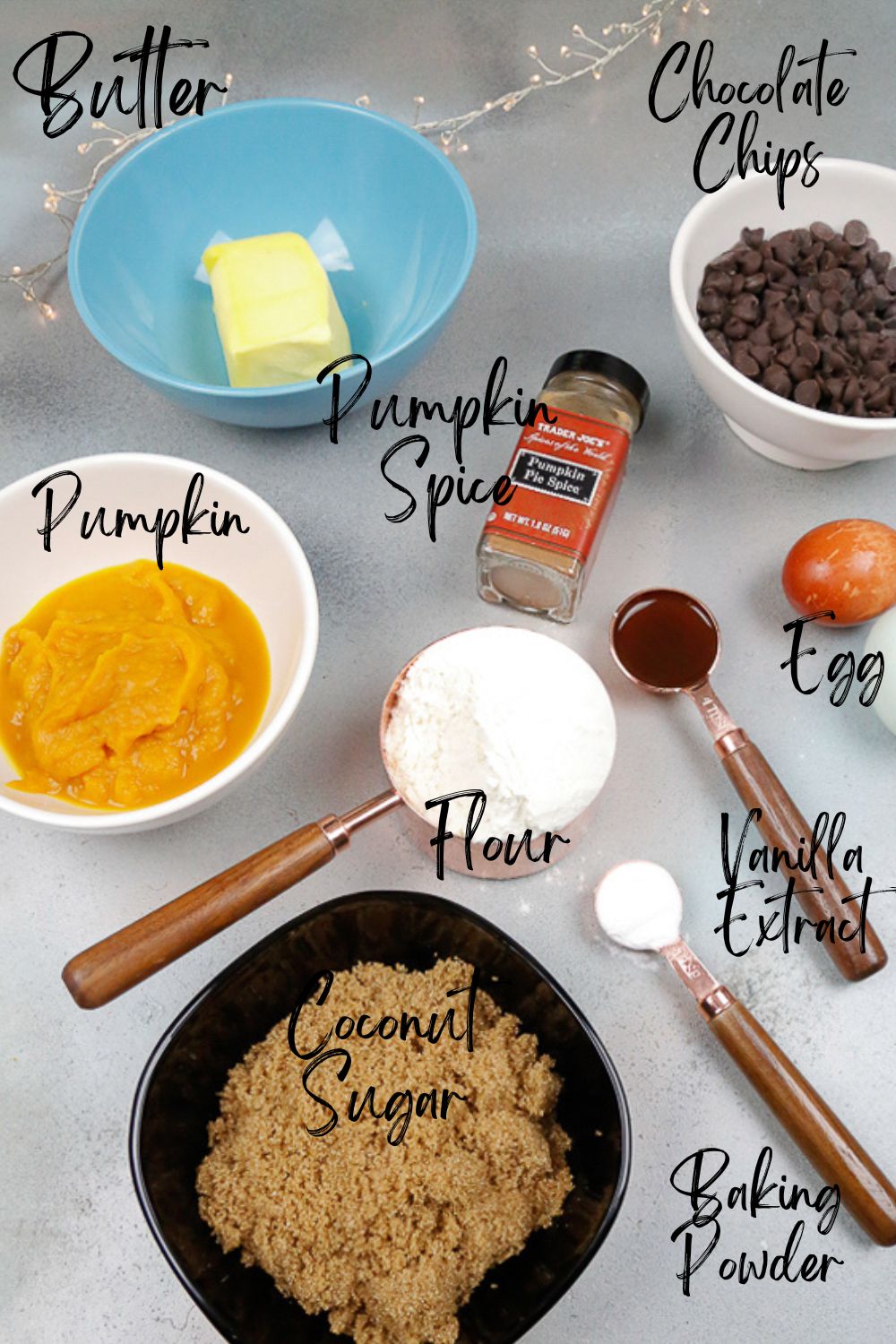 Ingredients for pumpkin brownies healthy flour, chocolate chips, pumpkin, baking powder, vanilla extract, egg, butter, coconut sugar, and pumpkin spice 