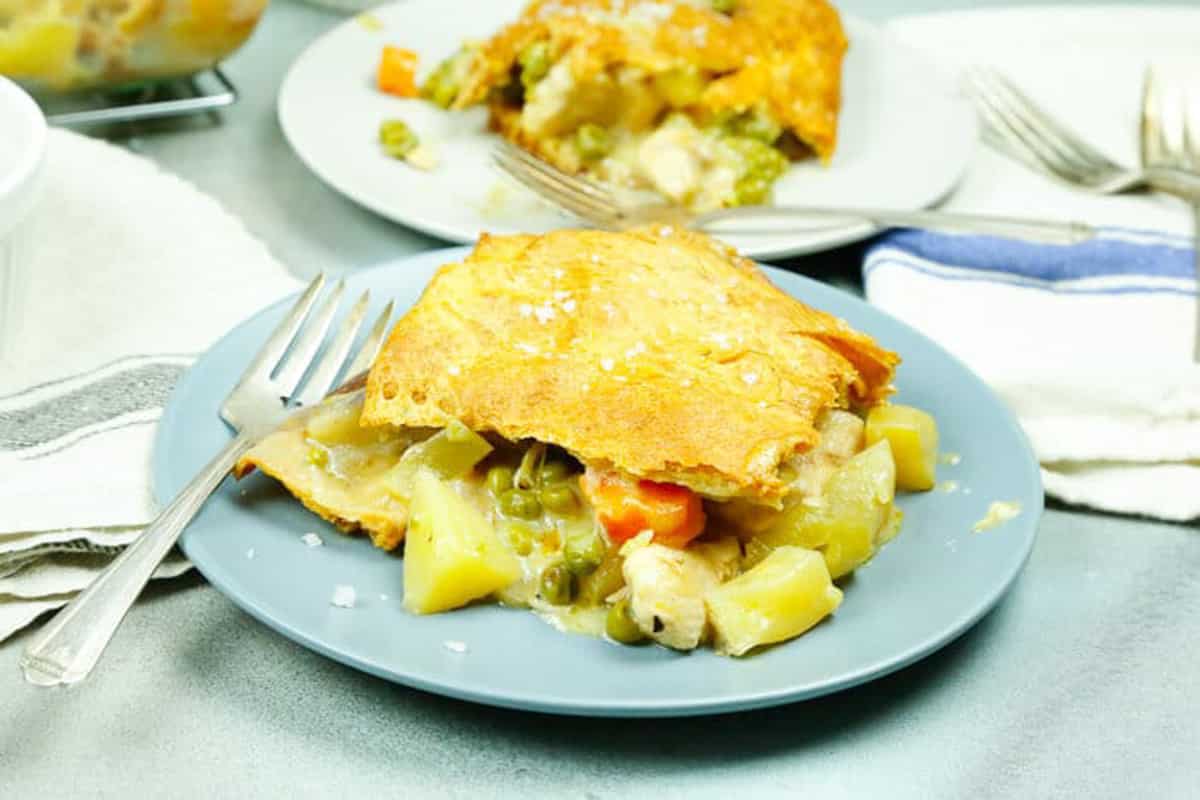 a slice of baked chicken pot pie with puff pastry 