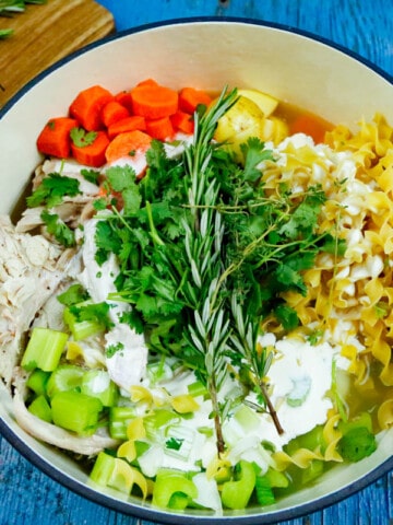 dutch oven full of ingredients for easy and delicious leftover turkey soup