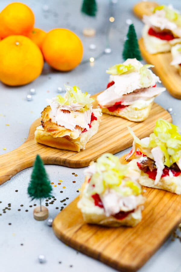 open-faced turkey sandwiches with layers of turkey, cranberry sauce, pepperoncini's