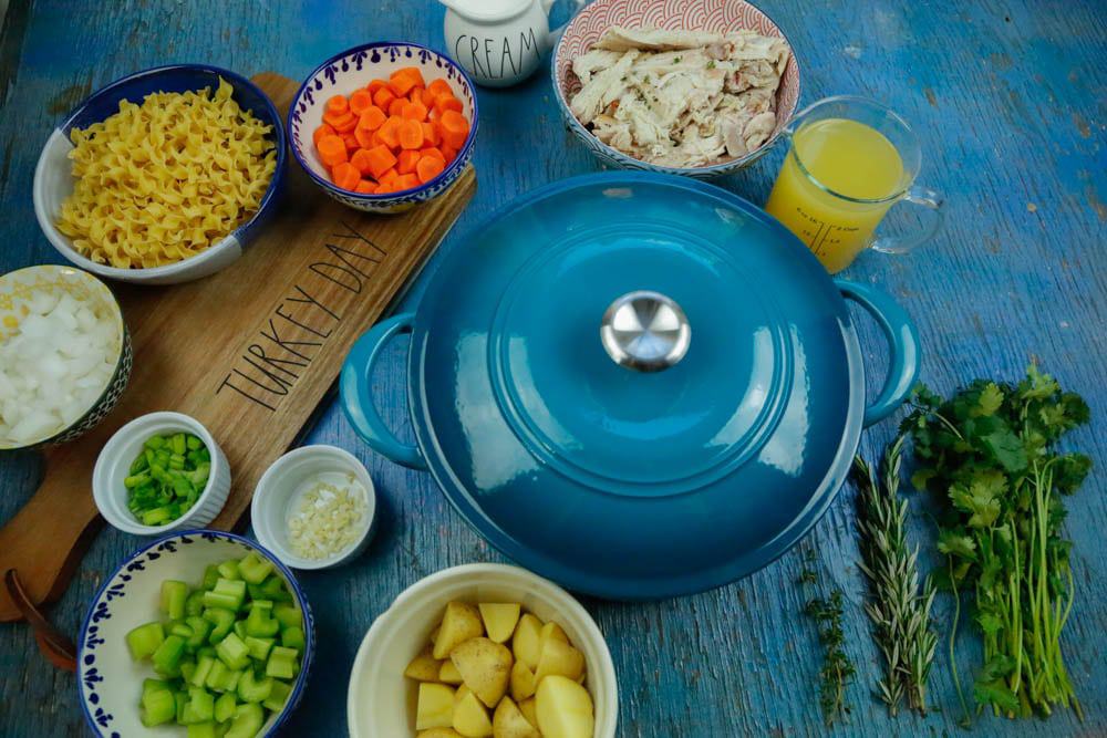 blue dutch oven with soup ingredients 
