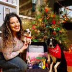 girl and dogs with Babbleboxx pawfect gift guide campaign in front of Christmas tree
