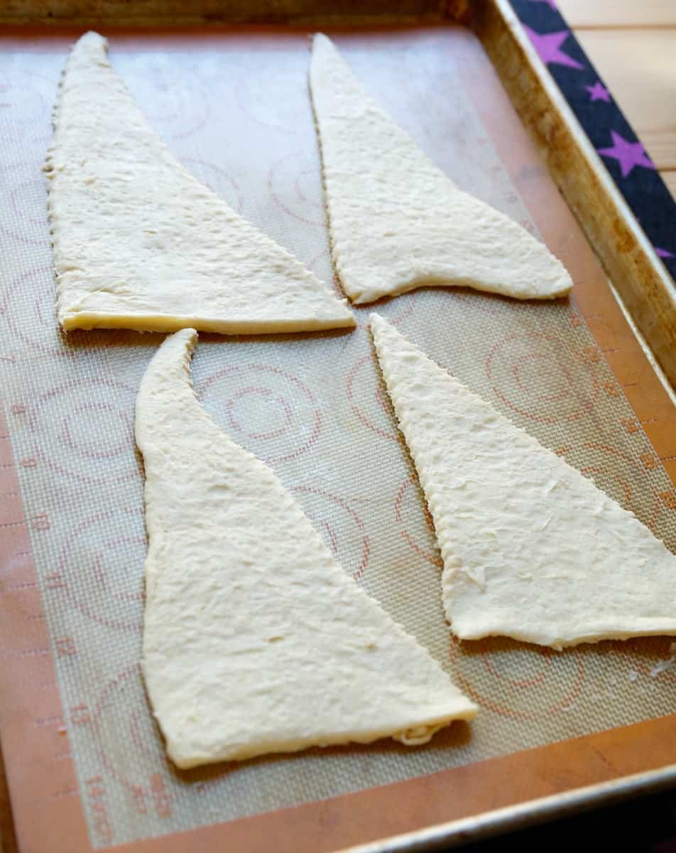 triangles crescent rolls on a baking sheet