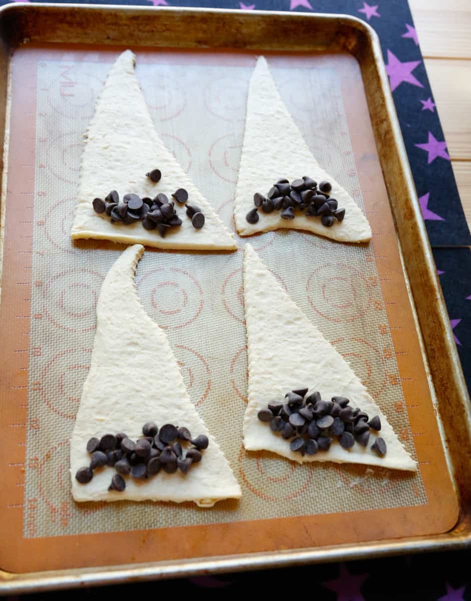crescent rolls and chocolate chips on a baking sheet 