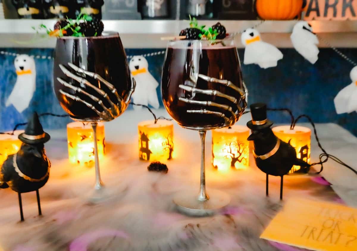 wine glasses with ghosts and dry ice and halloween lights 