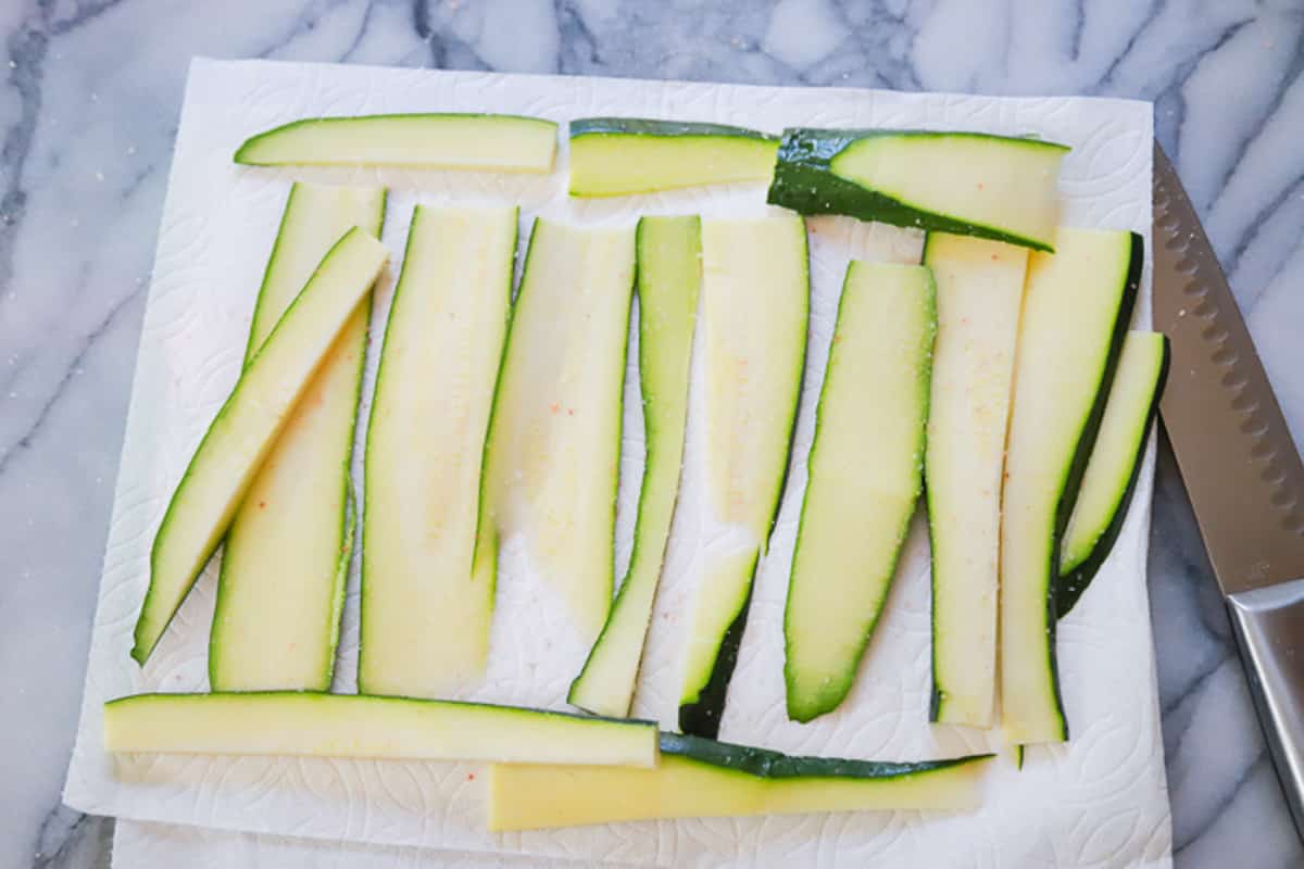 zucchini slices with salt on a paper towel zucchini casserole