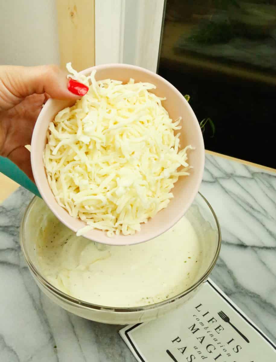add the shredded mozzarella cheese to the ricotta mixture 