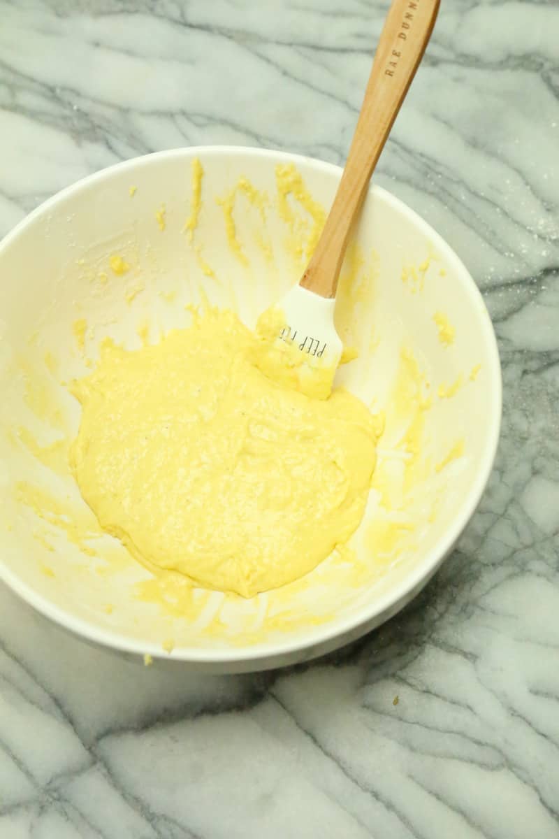 wet ingredients in a white mixing bowl egg buttermilk sour cream and vanilla extract