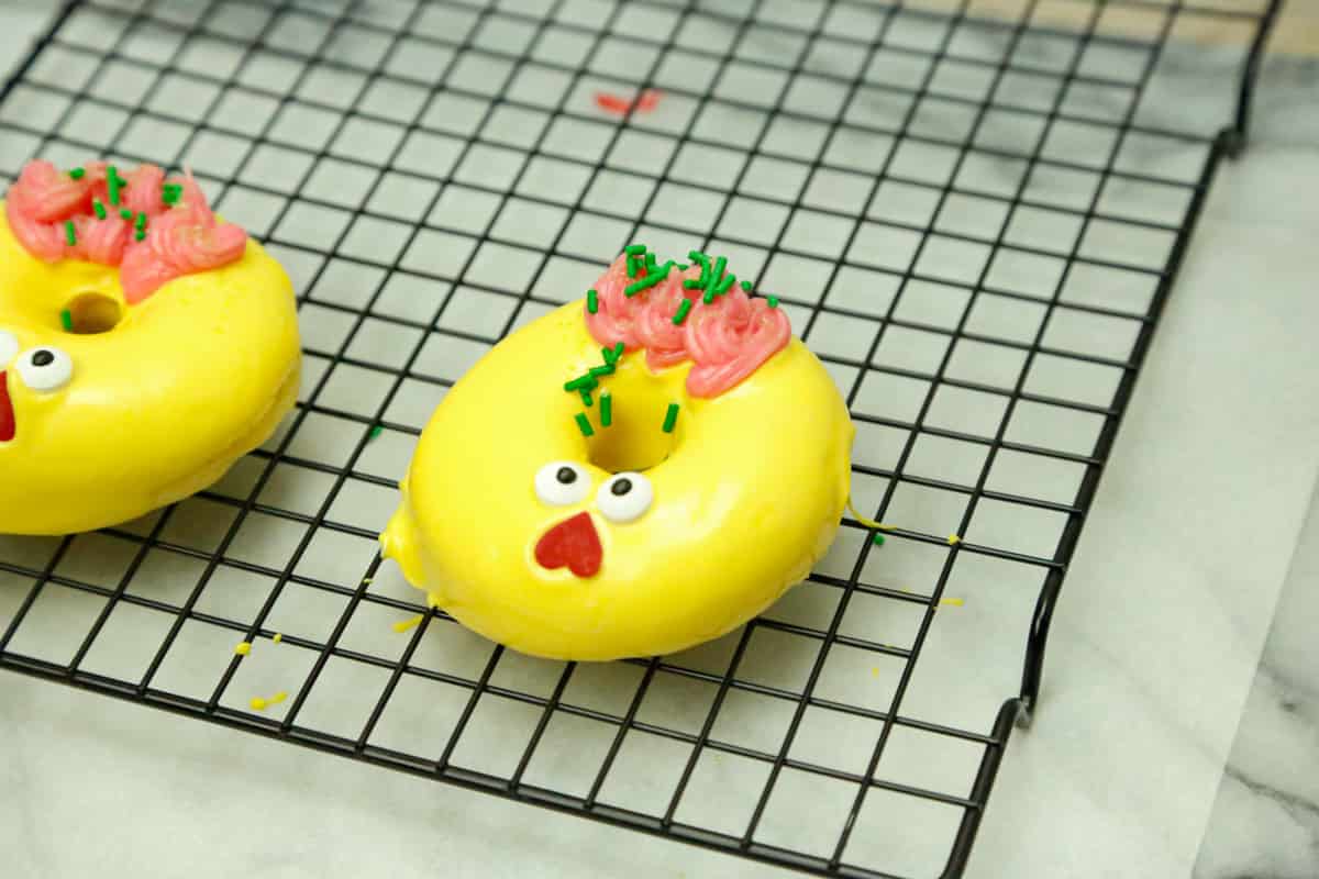 easter donuts decorated on a baking rack