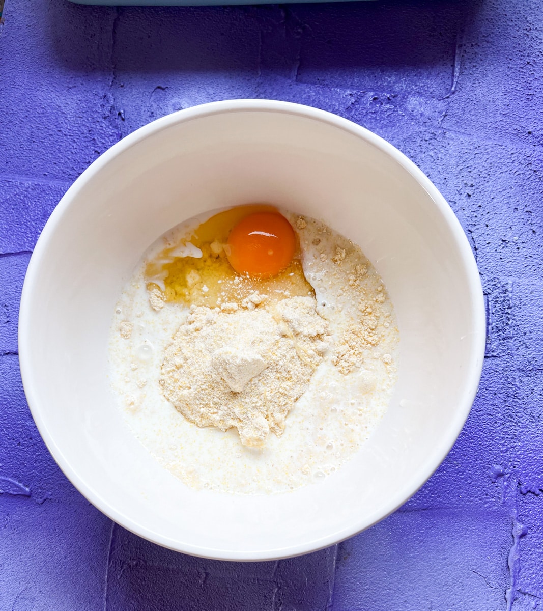 egg milk and Jiffy corn meal in a mixing bowl 
