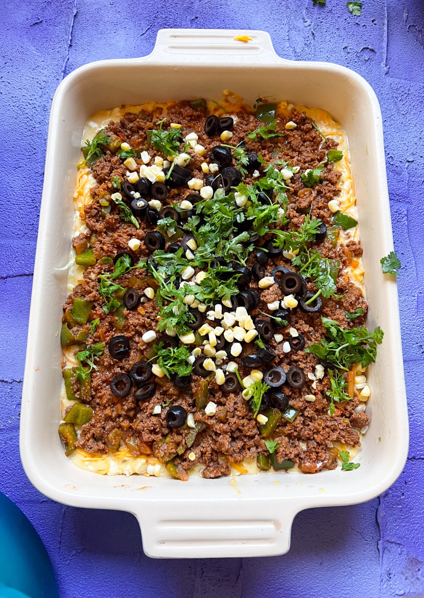 add a layer of black olives, fresh corn, and fresh cilantro to the beefy layer for Texas Tamale Pie 