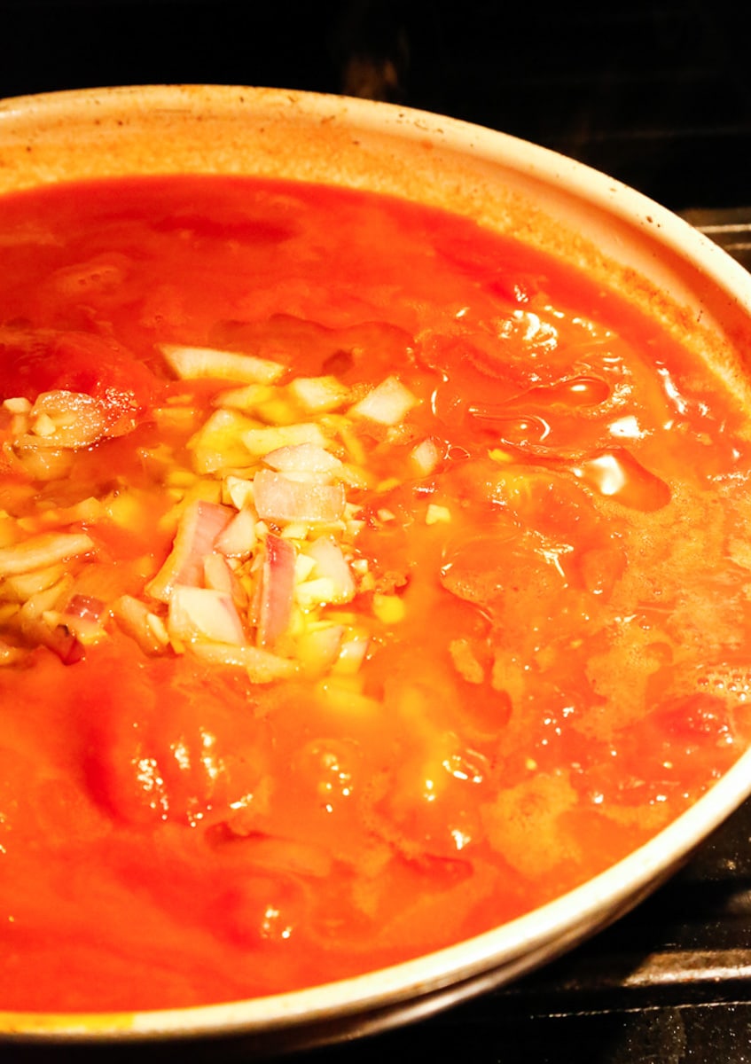 simmer the san Marzano tomato sauce in a saucepan 