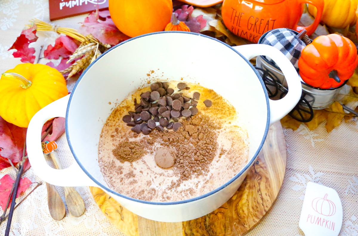 milk, heavy cream, cocoa powder, chocolate chips, vanilla extract in a large Dutch oven 