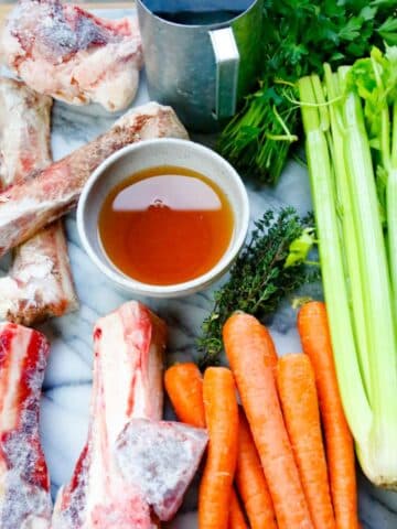 homemade bone broth recipe for dogs marrow bones, carrots, celery, apple cider vinegar water thyme and parsley