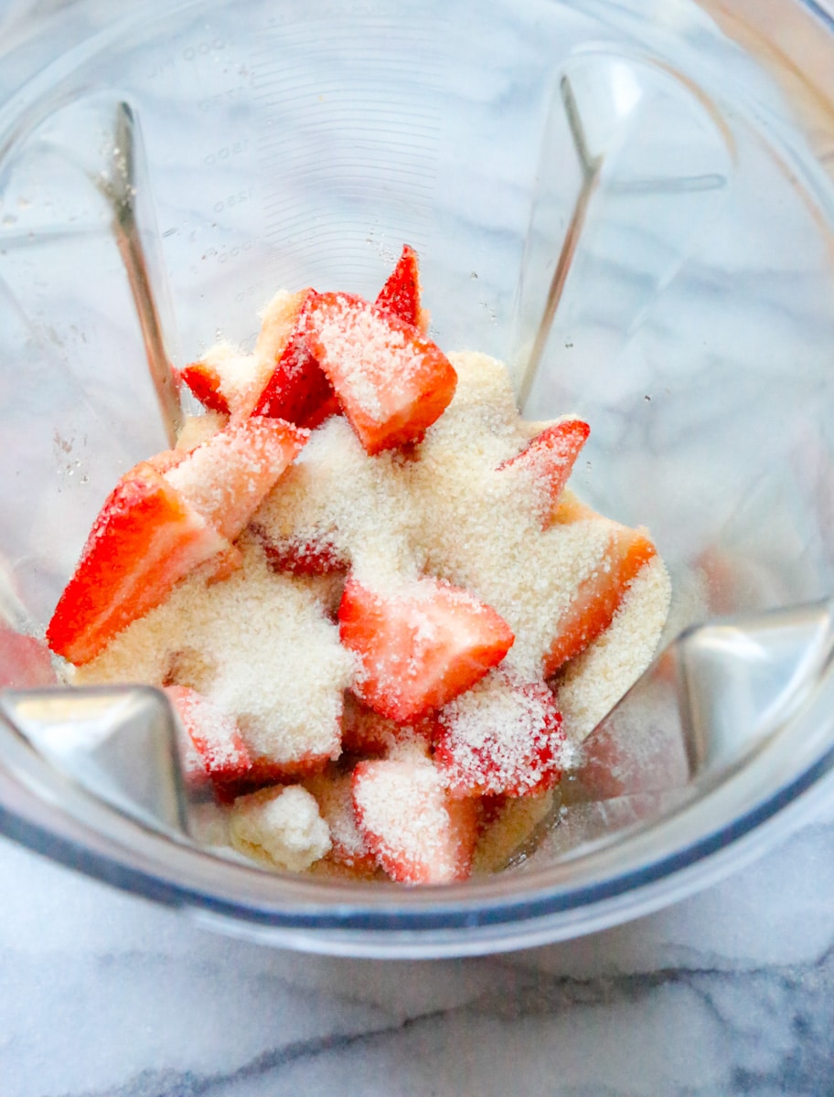 add the fresh strawberries and sugar to a blender 