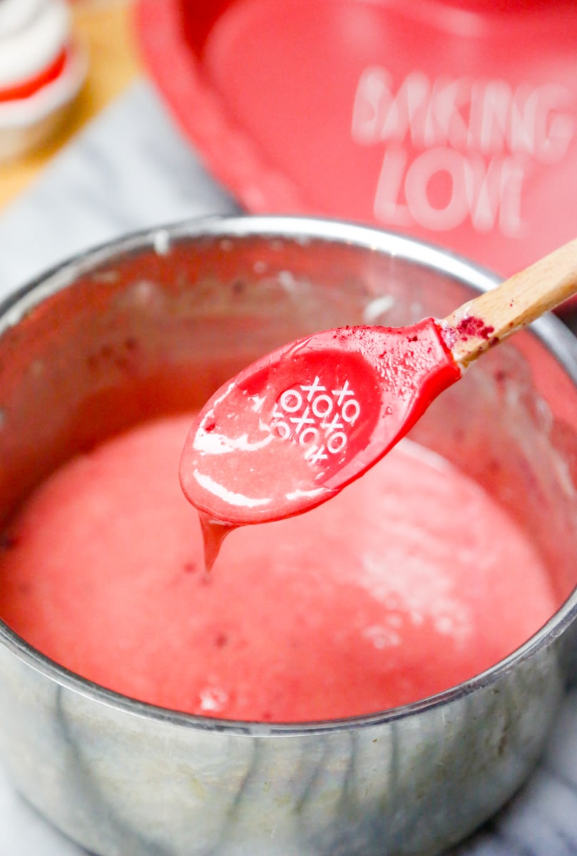 add the pink food coloring to the melted marshmallows with a baking love heart pan and an wooden spoon that says xoxo 