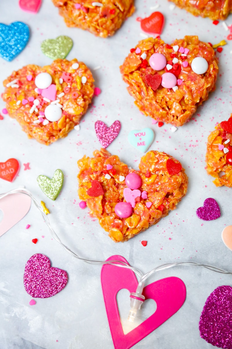 heart shaped crispy cornflake cookies topped with M&M's and Valentine's Day sprinkles 