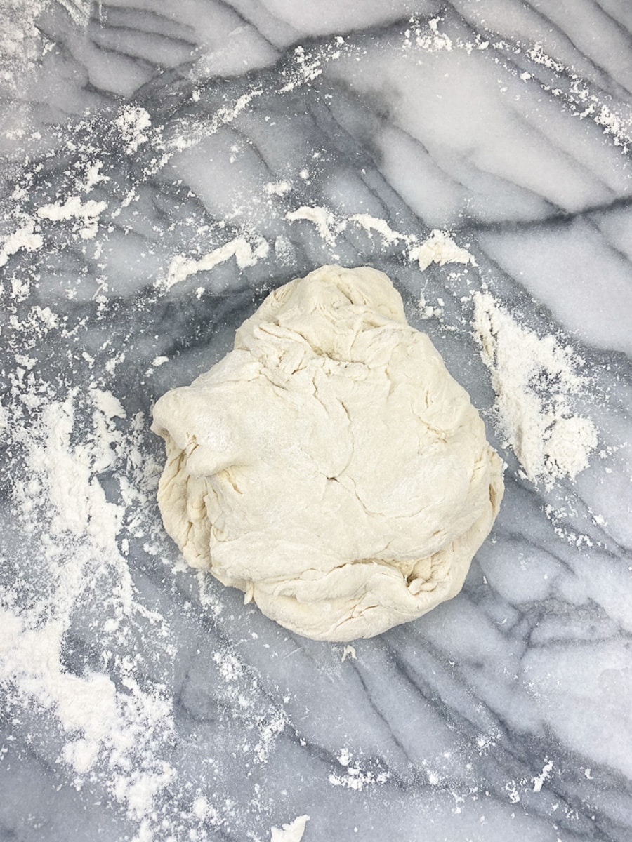 Knead the dough on a lightly floured surface until smooth and elastic and springs back when lightly pressed with 2-fingers for buttery buns 