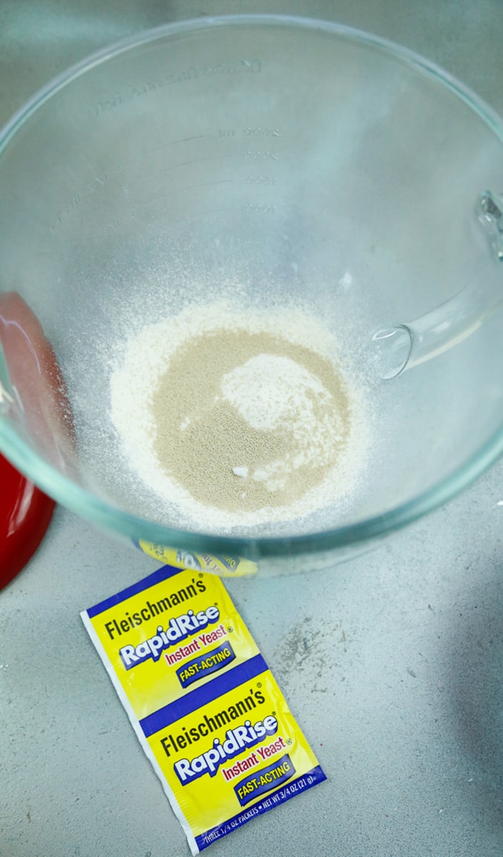 Combine ¾ cup flour, sugar, dry yeast, and salt in a large mixing bowl and stir until blended 