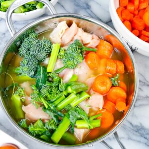 homemade dog food for dogs with skin allergies including chicken, broccoli carrots, and eggs and chicken bone broth