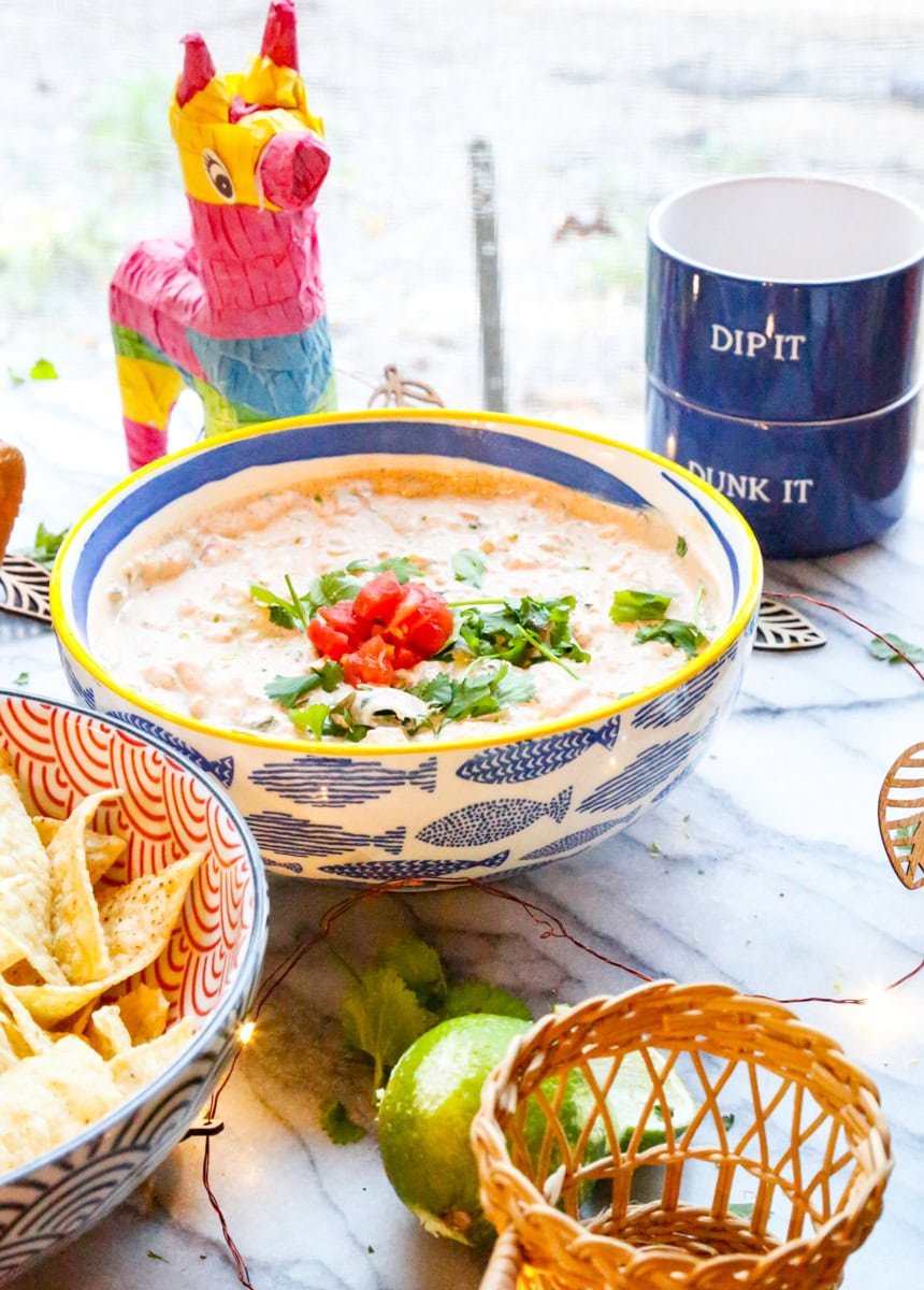 easy boat dip recipe topped with fresh cilantro and Rotel and a bowl of chips and a dip it dunk it bowls 