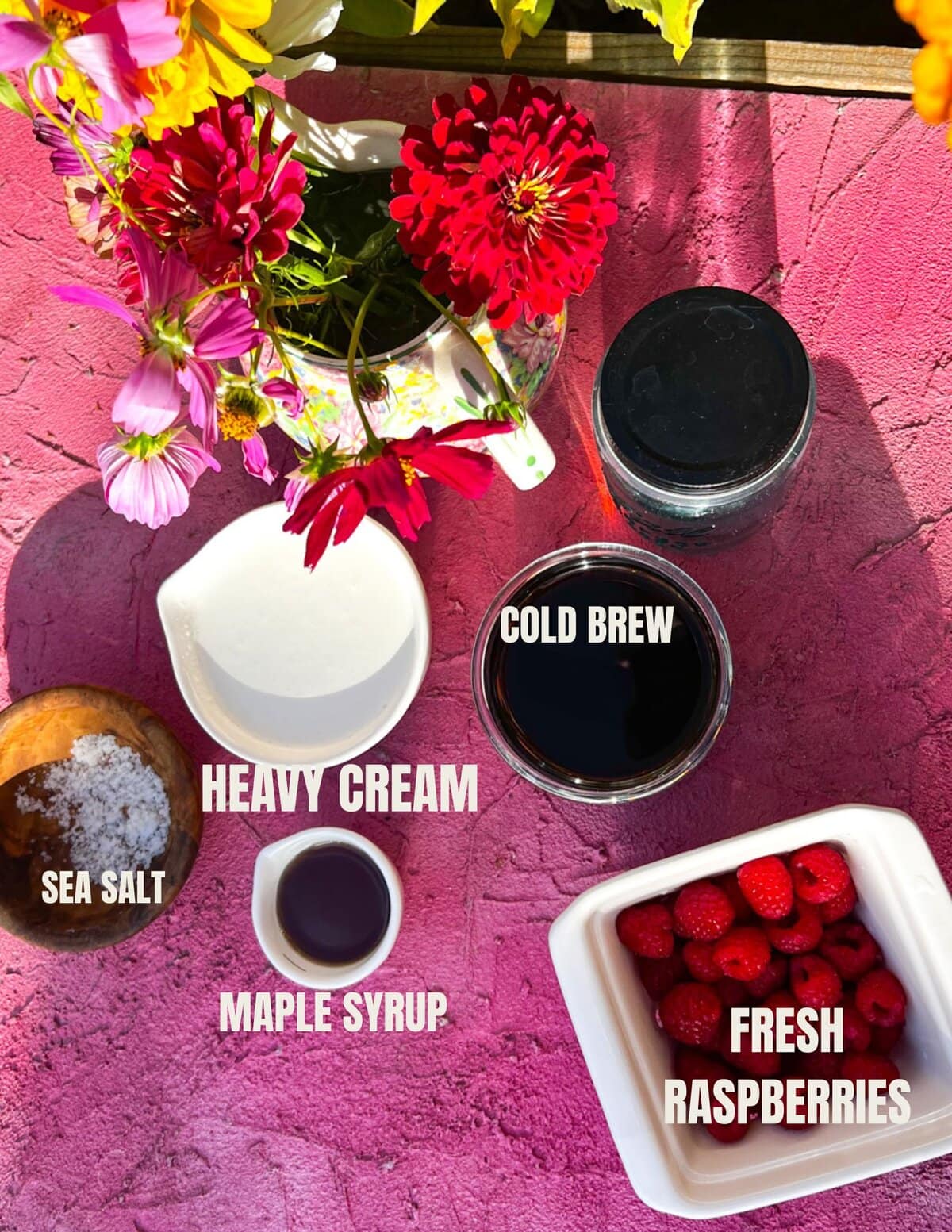 ingredients for raspberry cold foam include heavy cream, maple syrup, fresh raspberries, coffee