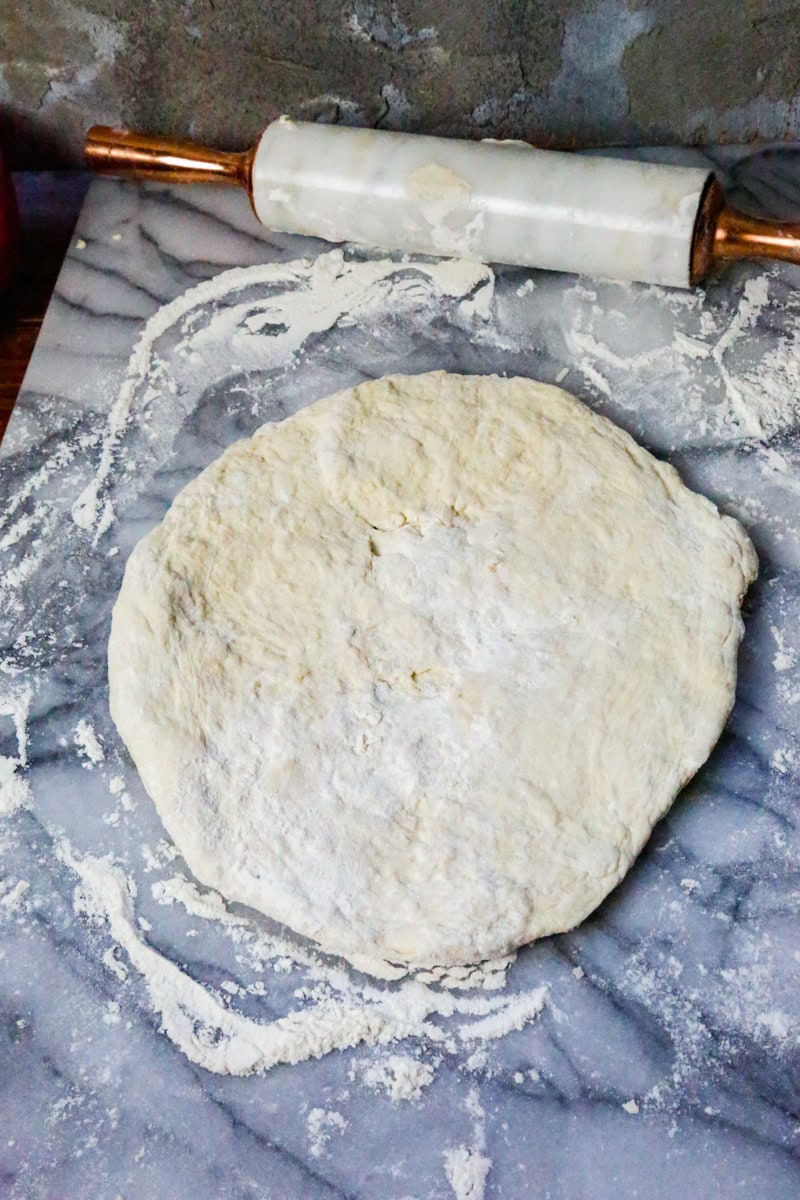 On a floured surface, roll out the dough and shape the pizza crust into the shape you prefer. Form the crust on the sides and when the pizza dough is the shape you prefer, lightly brush the pizza crust with Olive oil and top with flakey sea-salt before adding your favorite toppings.