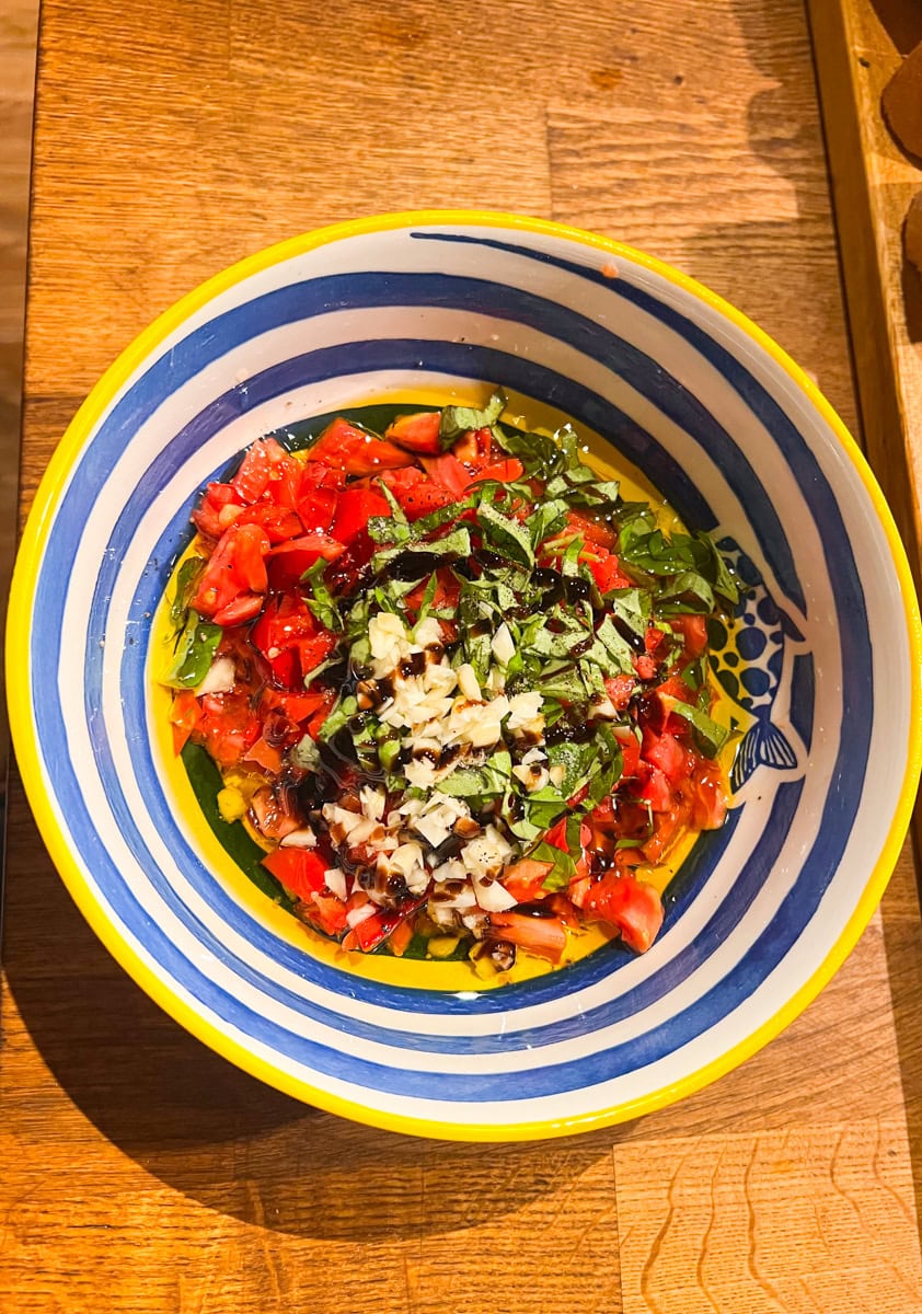 Add the fresh chopped basil, minced garlic, sea-salt, black pepper, and balsamic glaze and mix again until well combined. Set that aside and let the flavors meld together while you prep your Mozzarella cheese ghost slices. 