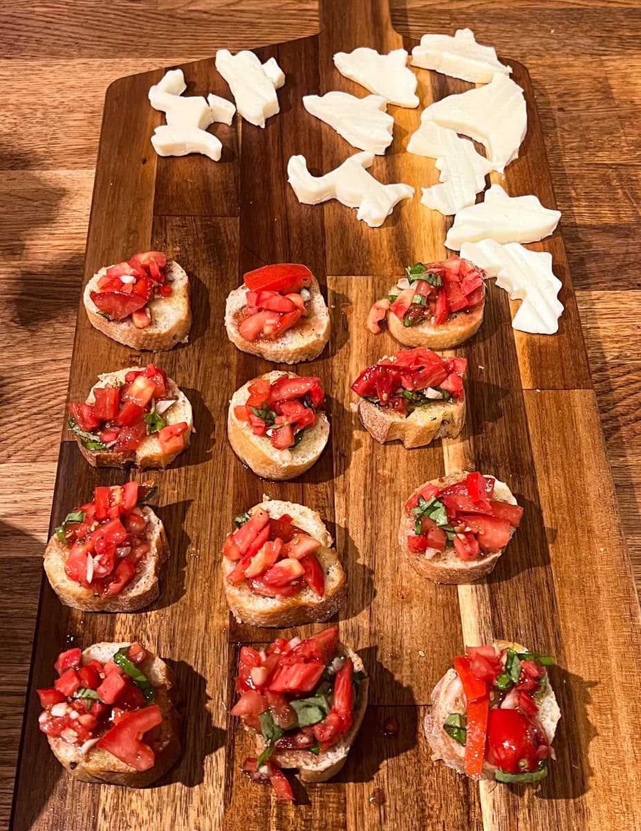 Spoon the prepared bruschetta tomato mixture over each toasted bread slice. 