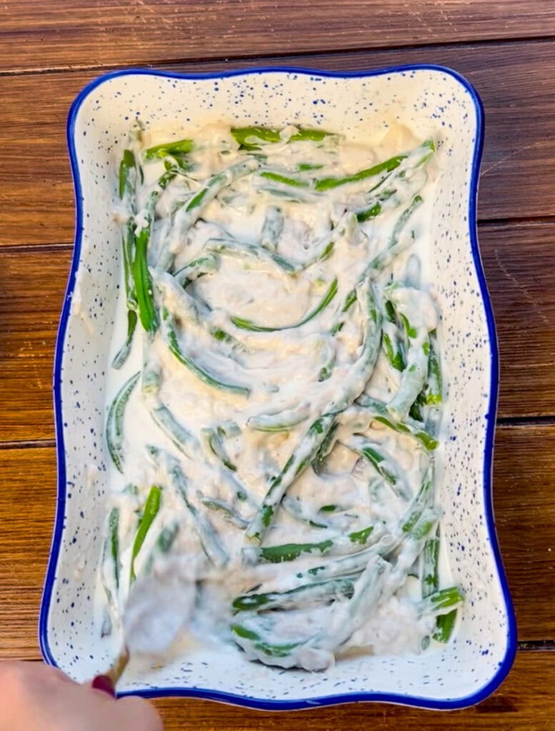 add the half-n-half and cream of mushroom soup to the green beans and mix well until combined.