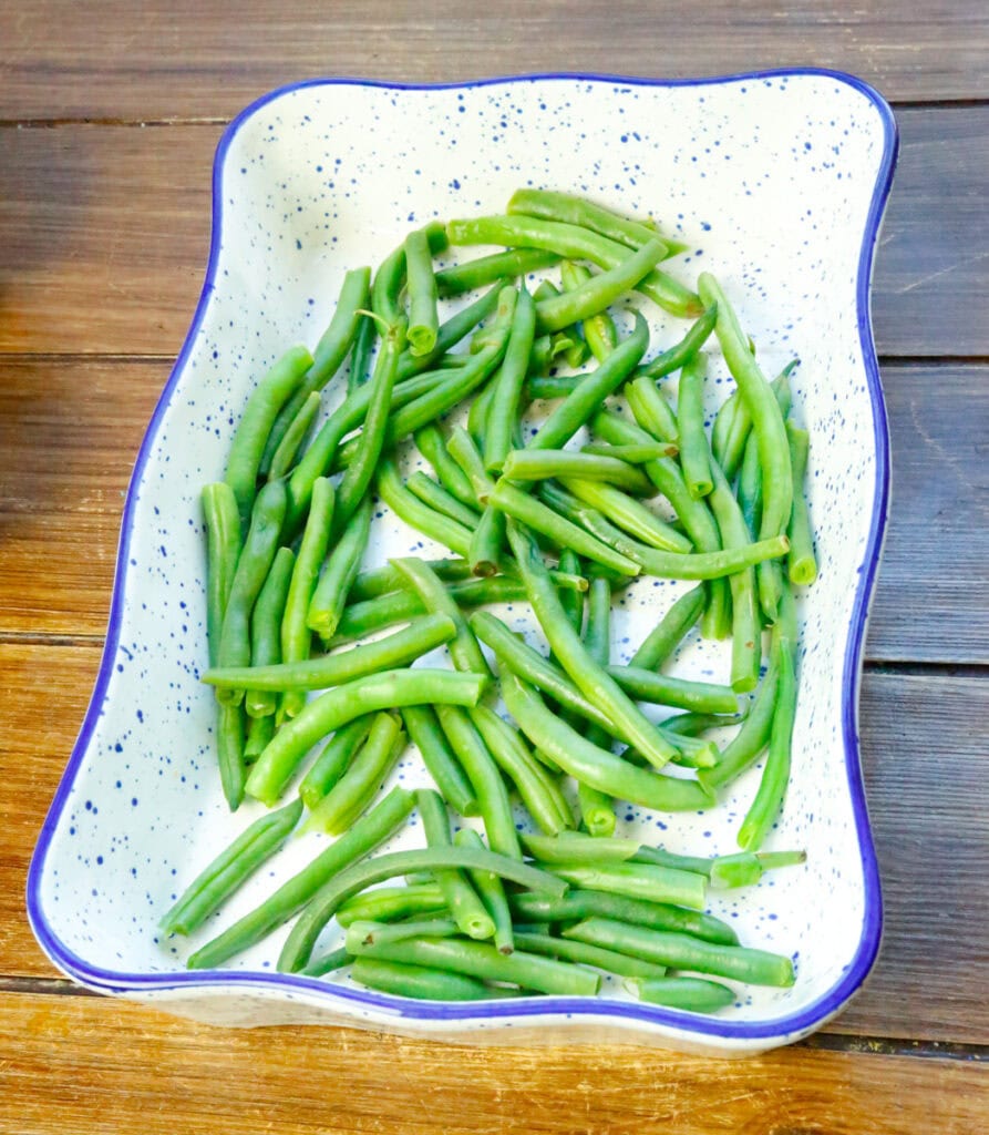 first blanch the green beans, don't boil them. A quick blanching will do, then add them to a sprayed casserole dish.