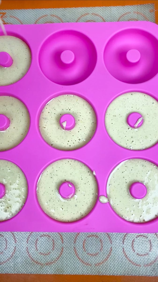 Spoon or pipe the batter into the donut cavities, filling each one about ⅔ full. Piping the batter gives the cleanest donut shape.