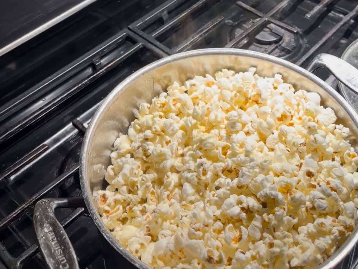 In a large pot with a lid, heat the vegetable oil over medium heat. Add 2–3 popcorn kernels and cover the pot. Once the kernels pop, add the remaining popcorn kernels and gently shake the pot to coat them in oil. Cover and cook, shaking occasionally, until popping slows to about 2 seconds between pops. Add the melted butter and sea salt on top of the popped popcorn and set aside. Keep the popcorn under the stockpot lid so it stays warm.