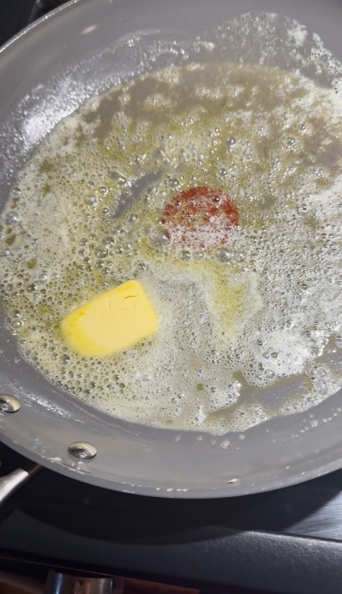 Heat a skillet or griddle over medium heat and lightly grease with butter.
