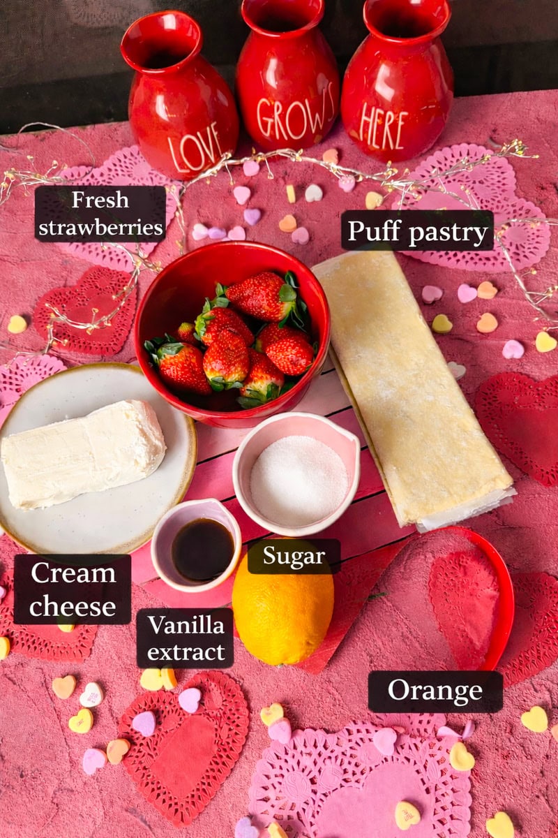 Ingredients for heart shaped strawberry Danish is fresh strawberries, store bought puff pastry, vanilla extract, granulated sugar, softened cream cheese, orange zest