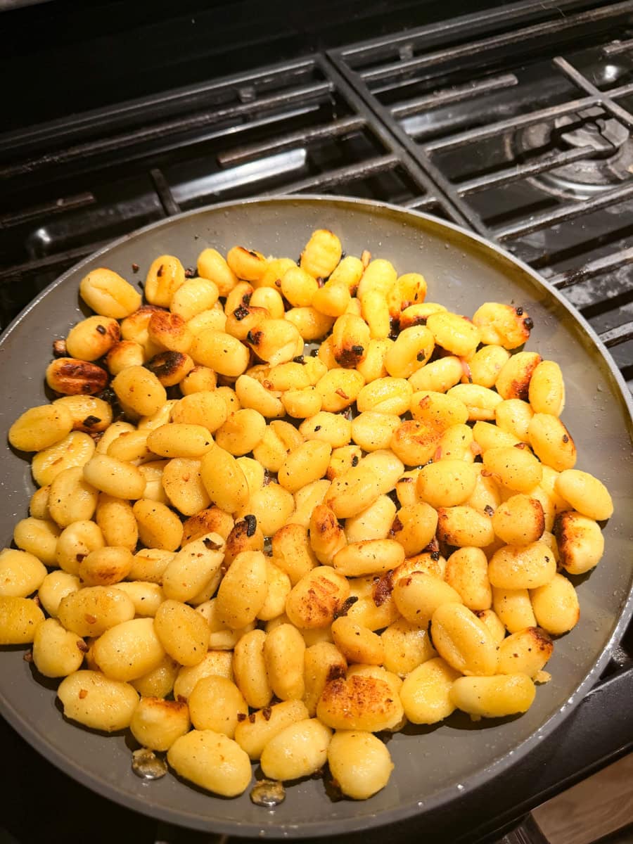 Heat olive oil in a large skillet over medium high heat. Add the gnocchi and sear over medium heat for 2-3 minutes. Repeat until all sides are golden and crisp.
