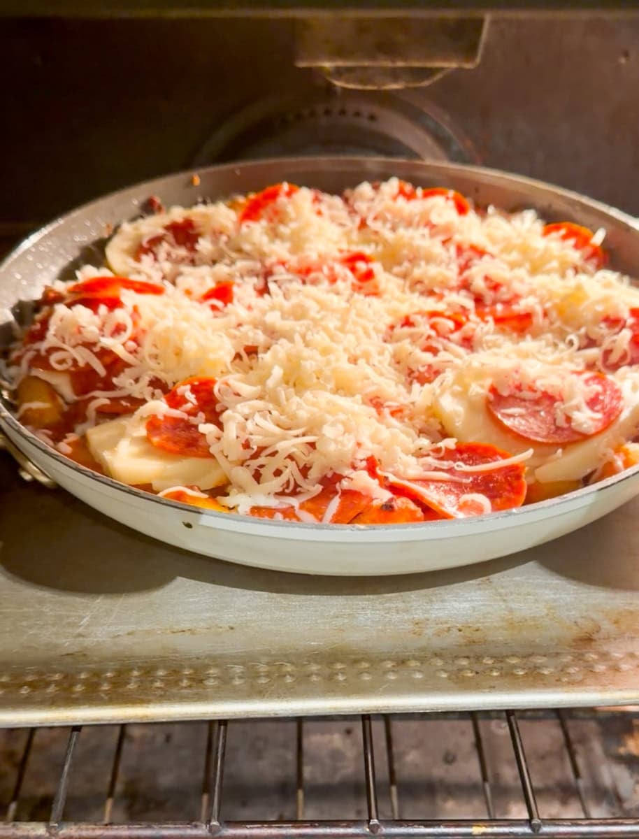 Place the prepared skillet on a baking sheet and bake in the oven at 350-degrees for 5-7 minutes until cheese starts to bubble.