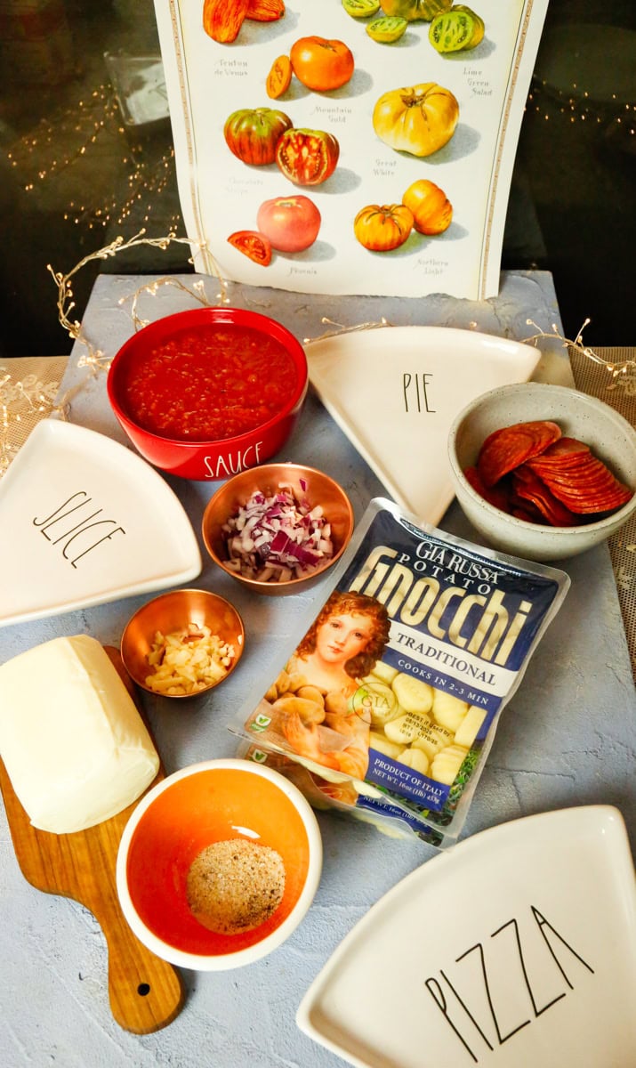 Ingredients for pizza gnocchi include traditional gnocchi, marinara sauce, fresh mozzarella cheese, fresh chopped garlic, and yellow onion, pepperoni slices, and pizza seasoning 
