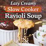 Creamy slow cooker ravioli soup with ground beef, cheese, and tomato broth in a white bowl with crusty bread – easy crockpot ravioli soup recipe.
