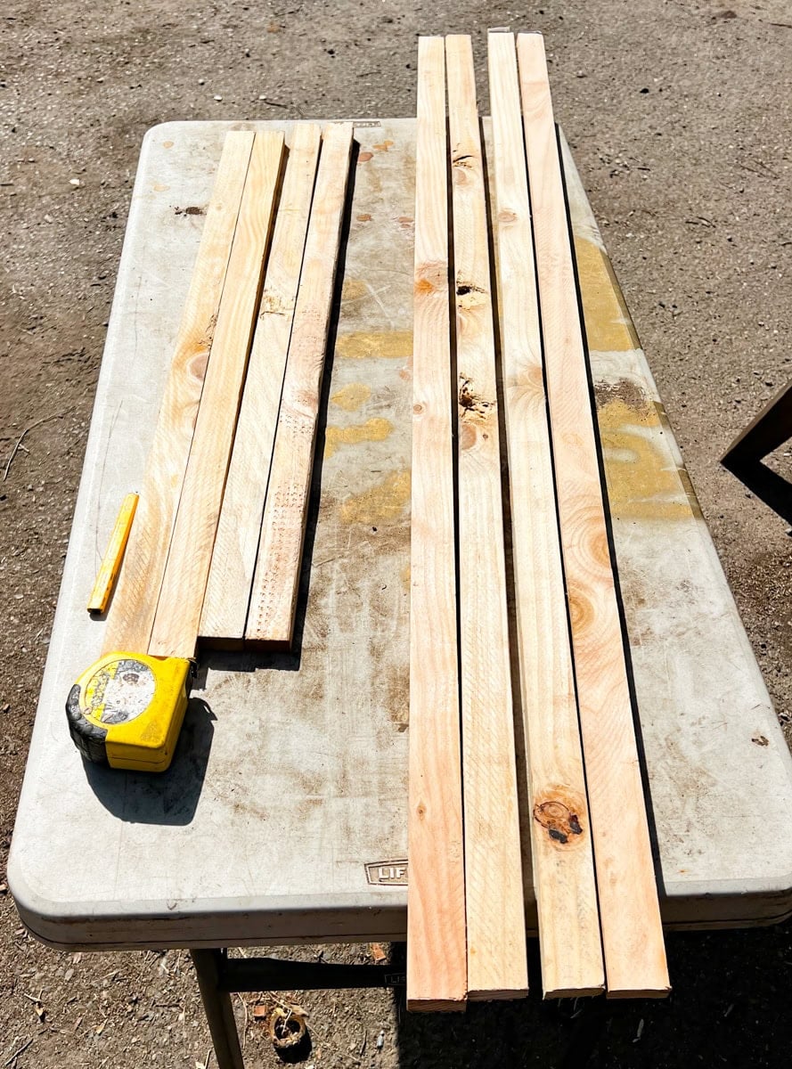 1x3 wood boards and hog wire panel arranged for building a wooden garden trellis frame
